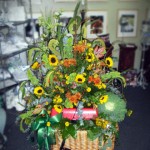 Fishing themed arrangement featuring Sunflowers and Kale. Fishing themed arrangement featuring Sunflowers and Kale.