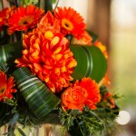 Oversized orange flowers and Tea Leaf loops create texture and dimension.