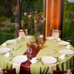 A bronze candelabra adds candlelight and is surrounded by cups of fresh flowers.