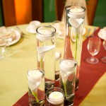 Classic and sleek, submerged Calla Lillies in cylinders with floating candles.