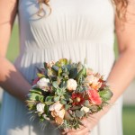 Jessica shows off her bridal bouquet of succulents, garden flowers, and metallic accents.