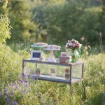 Lovely garden flowers and succulents adorn this sweets display case.
