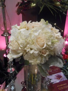 Fluffy textures of hydrangea, roses, and dusty miller give this bouquet rustic elegance.