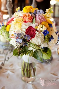 Simply beautiful bridal bouquet of wildflowers in cream and pops of color. Photo by: Photography by Kristen