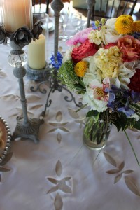 A handmade linen tablecloth was the perfect detailed foundation for this tablescape and wildflower bouquet.