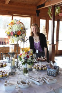 Manager and designer Erin Stoffregen with her floral creations for a tablescape at Rockford Wed 2013.