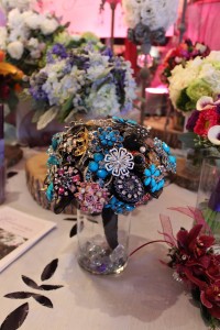 This brooch bouquet is brightened by a pop of turquoise.