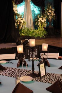 A black candelabra with crystals as a rental centerpiece on a guest table.