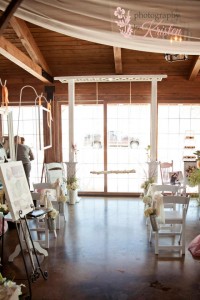 A trellis with a handcrafted log swing is a whimsical non-traditional altar ceremony setting. Photo by: Photography by Kristen