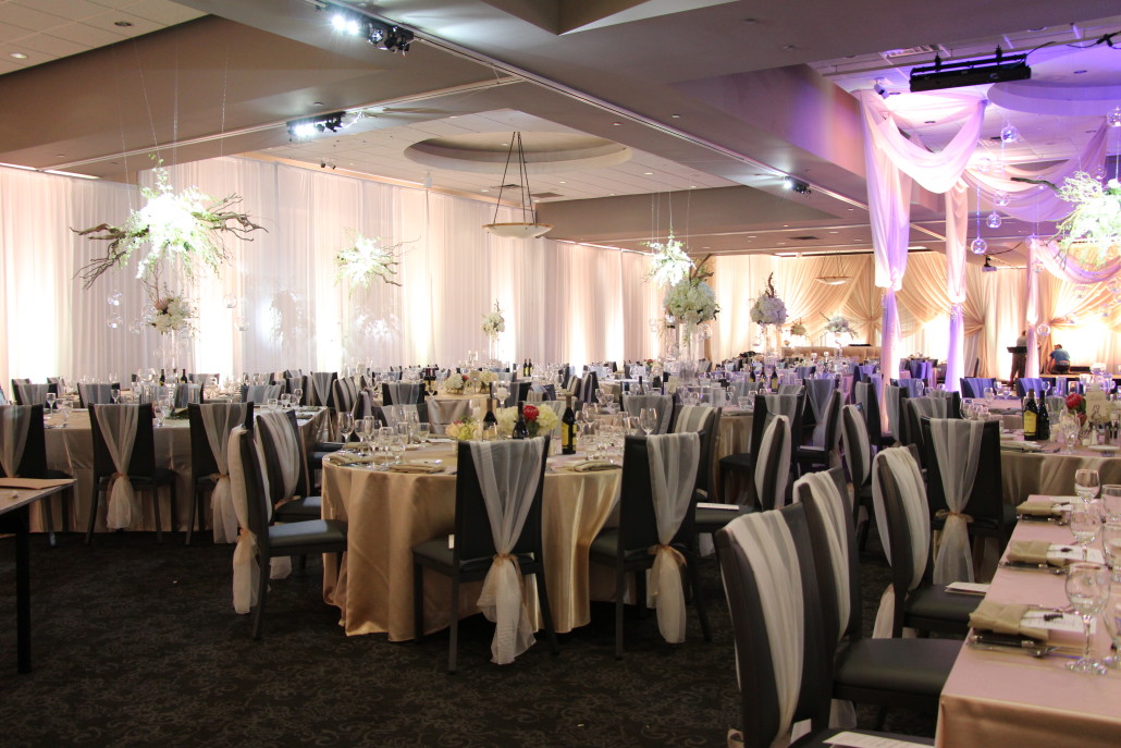 The tables were dressed in specialty champagne linens. Event Floral had custom sheer ivory chiffon chair sleeves made to dress up the chairs.