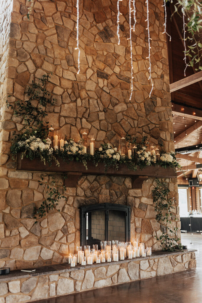 fireplace with candles and floral