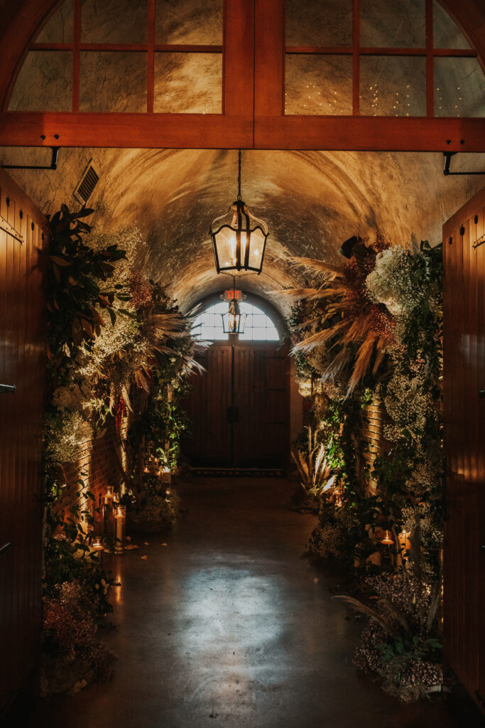 Arch Hallway decorated with beautiful flowers, greenery and feathers